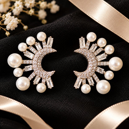 Crescent Pearl & Baguette Zircon Earrings featuring white pearls in graduated sizes, clear baguette-cut stones and a zircon-encrusted crescent in a silver-tone setting.