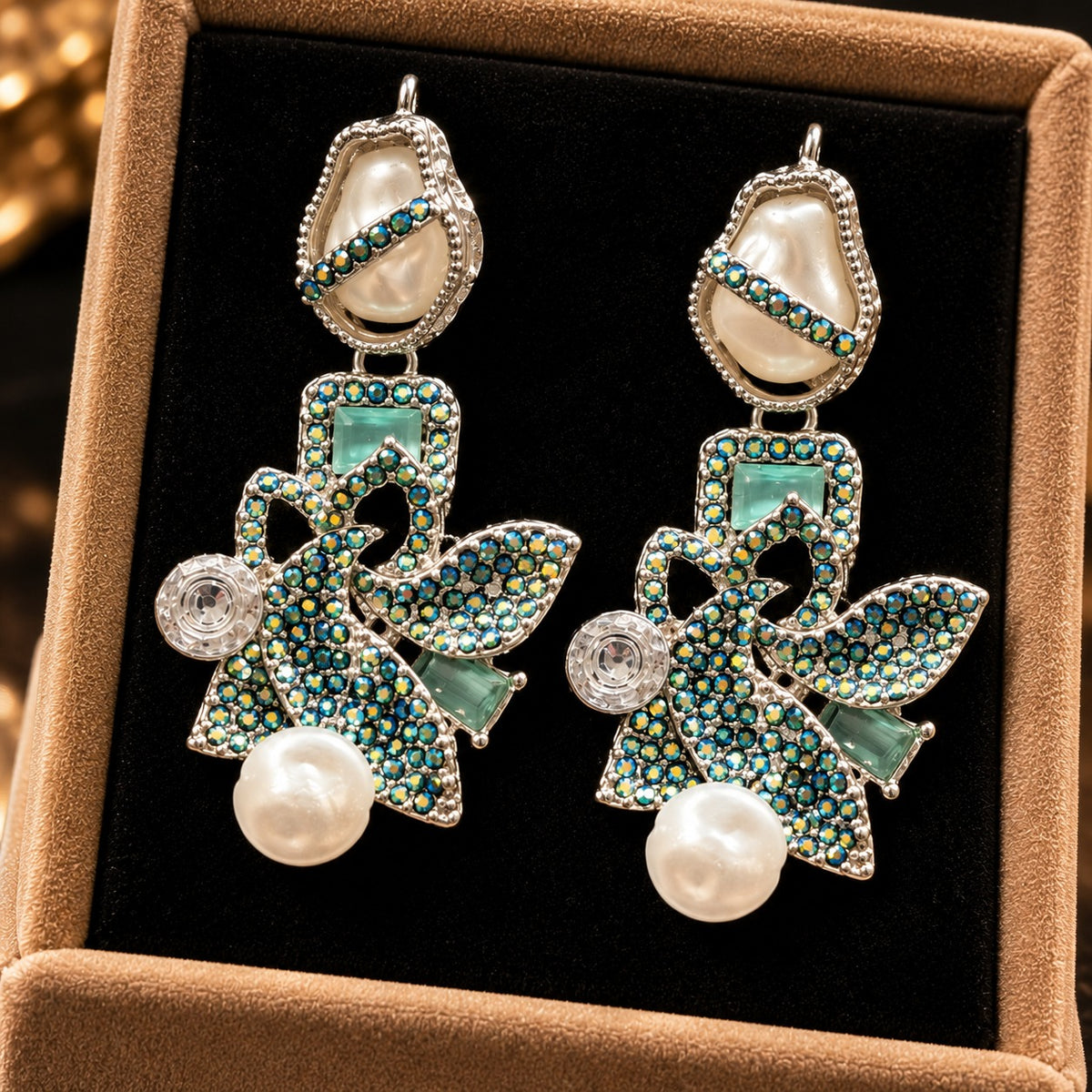 Baroque Mosaic Earrings featuring sculptural floral detailing, iridescent teal crystals, geometric accents, and ivory pearl drops.