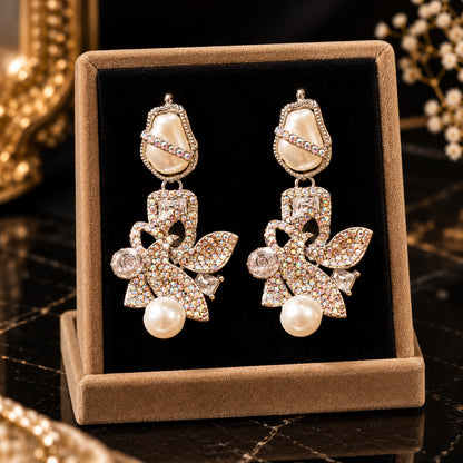 Baroque Mosaic Earrings featuring sculptural floral detailing, iridescent crystals, geometric accents, and ivory pearl drops.