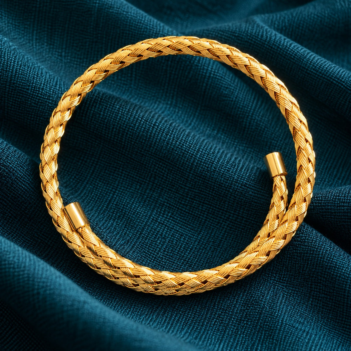 Top view of the Aurelia Weave Cuff Bracelet highlighting its circular open-cuff silhouette, detailed interwoven pattern, and polished gold-tone finish.