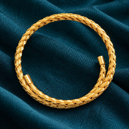 Top view of the Aurelia Weave Cuff Bracelet highlighting its circular open-cuff silhouette, detailed interwoven pattern, and polished gold-tone finish.
