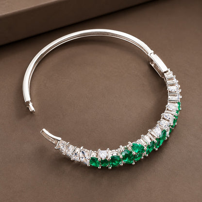 Open silver-tone zircon bracelet showing its hinged construction and clasp-style locking mechanism.