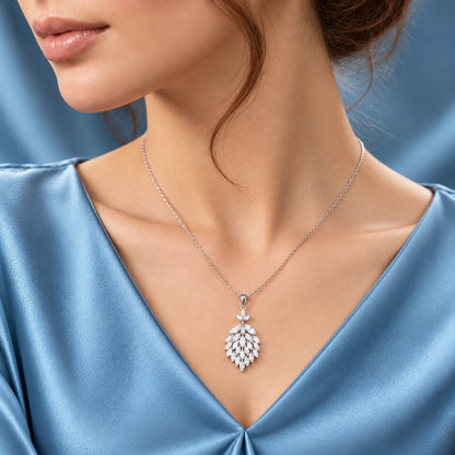 Model wearing the Cascade Willow Zircon Pendant on a delicate silver-tone chain, styled with a soft blue satin dress.