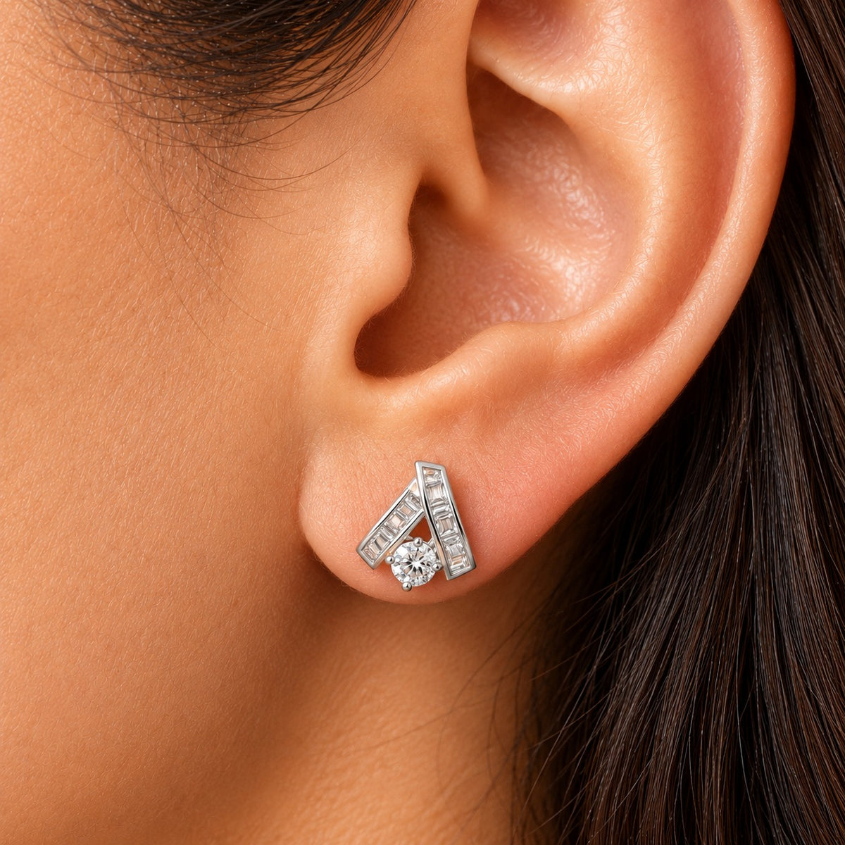 Close-up of a woman wearing the Veyra Duet Zircon Stud, showcasing its contemporary geometric silver-tone design with baguette-cut and round-cut clear zircon stones.