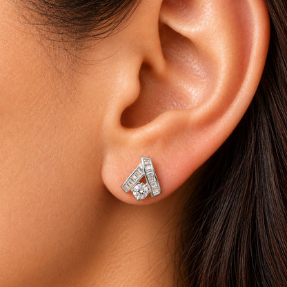 Close-up of a woman wearing the Veyra Duet Zircon Stud, showcasing its contemporary geometric silver-tone design with baguette-cut and round-cut clear zircon stones.