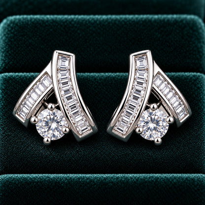 Veyra Duet silver-tone zircon stud earrings featuring two angled baguette-cut zircon bands and a brilliant round-cut clear zircon, displayed on luxurious deep teal velvet.