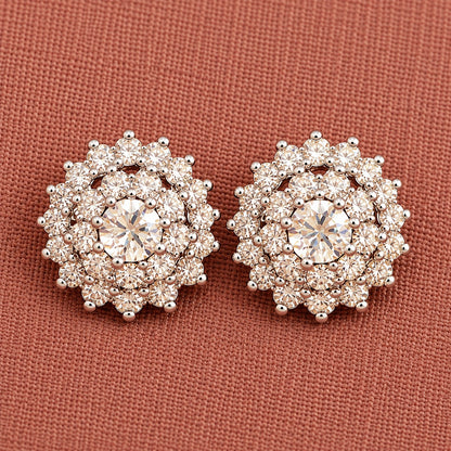 Detailed close-up of  clear Kensington Cluster Studs highlighting the faceted mint-green centre stones, intricate circular arrangement and surrounding clear zircon detailing.