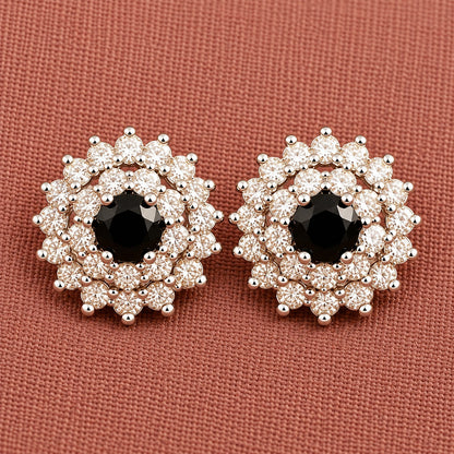 Detailed close-up of black  Kensington Cluster Studs highlighting the faceted mint-green centre stones, intricate circular arrangement and surrounding clear zircon detailing.