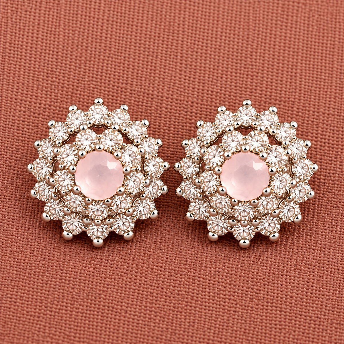 Detailed close-up of soft  pink Kensington Cluster Studs highlighting the faceted mint-green centre stones, intricate circular arrangement and surrounding clear zircon detailing.
