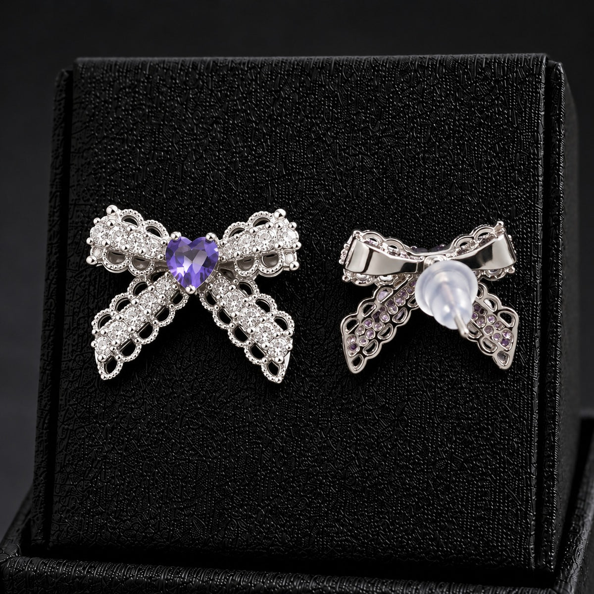 Front and reverse views of Amorette Bow Studs showing intricate silver-tone construction, stud posts, and transparent push-back closures