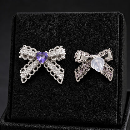 Front and reverse views of Amorette Bow Studs showing intricate silver-tone construction, stud posts, and transparent push-back closures