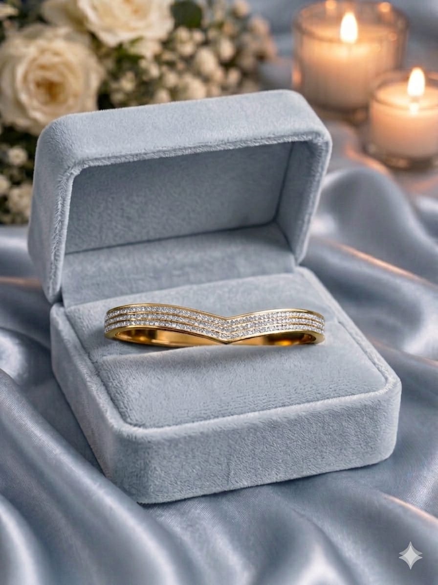 Gold V-shape bracelet in luxury velvet box with soft ambient lighting