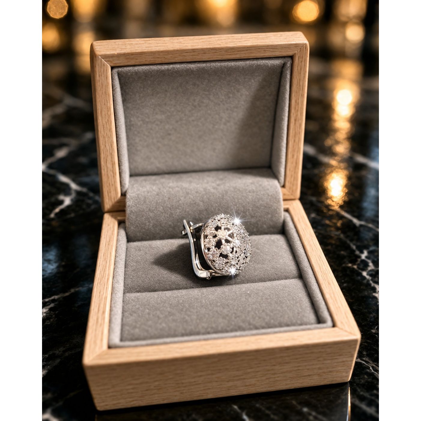 Side angle view of silver dome crystal earrings showing structure and clasp detail in jewelry box