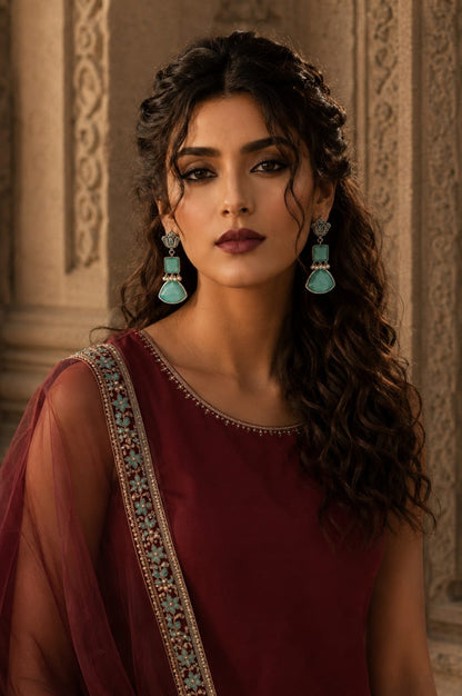 Model wearing Legacy Collection antique silver-tone mint green statement earrings with faceted stones and pearl accents.
