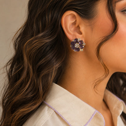 Woman wearing premium lavender purple floral crystal stud earrings with pear-cut stones in a luxury side-profile portrait.
