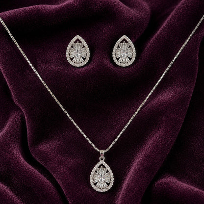 Dropline S925 silver earrings and pendant set with teardrop frames, clear zircon centres and baguette-style detailing displayed on deep plum velvet