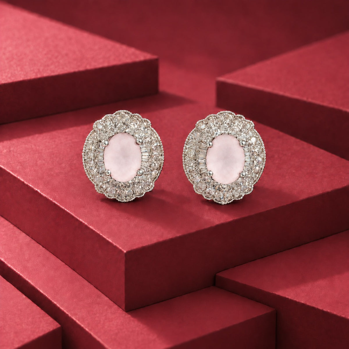 Verdanza Oval statement stud earrings with a faceted oval light pale pink centre stone and detailed clear zircon surround in a polished silver-tone setting