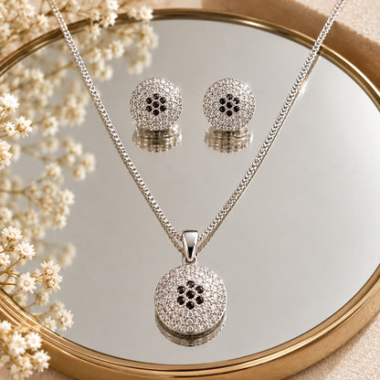 S925 silver Vela Dot earrings and pendant set displayed on a mirror, showcasing the circular textured design and clear zircon detailing.