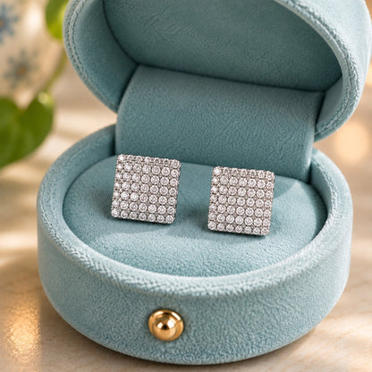 Lumière Mosaic square silver pavé crystal stud earrings displayed in a luxury pastel blue velvet jewellery box by TIAS Collection.