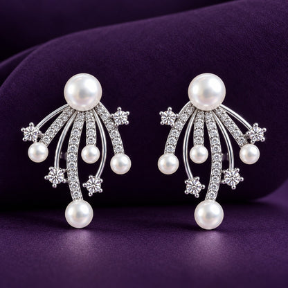  Close up of Pearl Drift Stud Earrings with white pearls, curved silver-tone strands and delicate clear zircon accents displayed on a deep purple background.