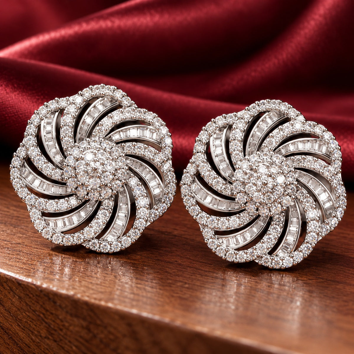  Close up of Silver-tone circular statement stud earrings with swirling openwork design and clear zircon stone detailing