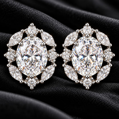 Lustre Vale S925 stud earrings with large oval clear zircon centre stones and marquise-cut zircon accents, displayed on textured black fabric.
