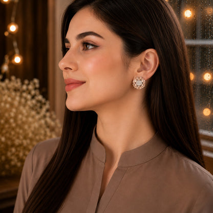 Woman wearing elegant floral crystal beige stud earrings with marquise-cut gemstone petals and a sparkling pavé center in a luxury side-profile portrait.