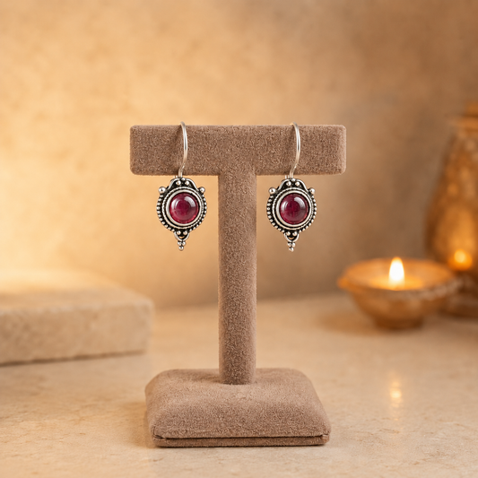 Antique silver vintage round  hot pink gemstone drop earrings on beige velvet jewellery stand with polished cabochon