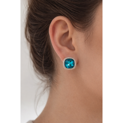 Silver cushion-cut turquoise crystal stud earring worn on female model highlighting colour and shape.