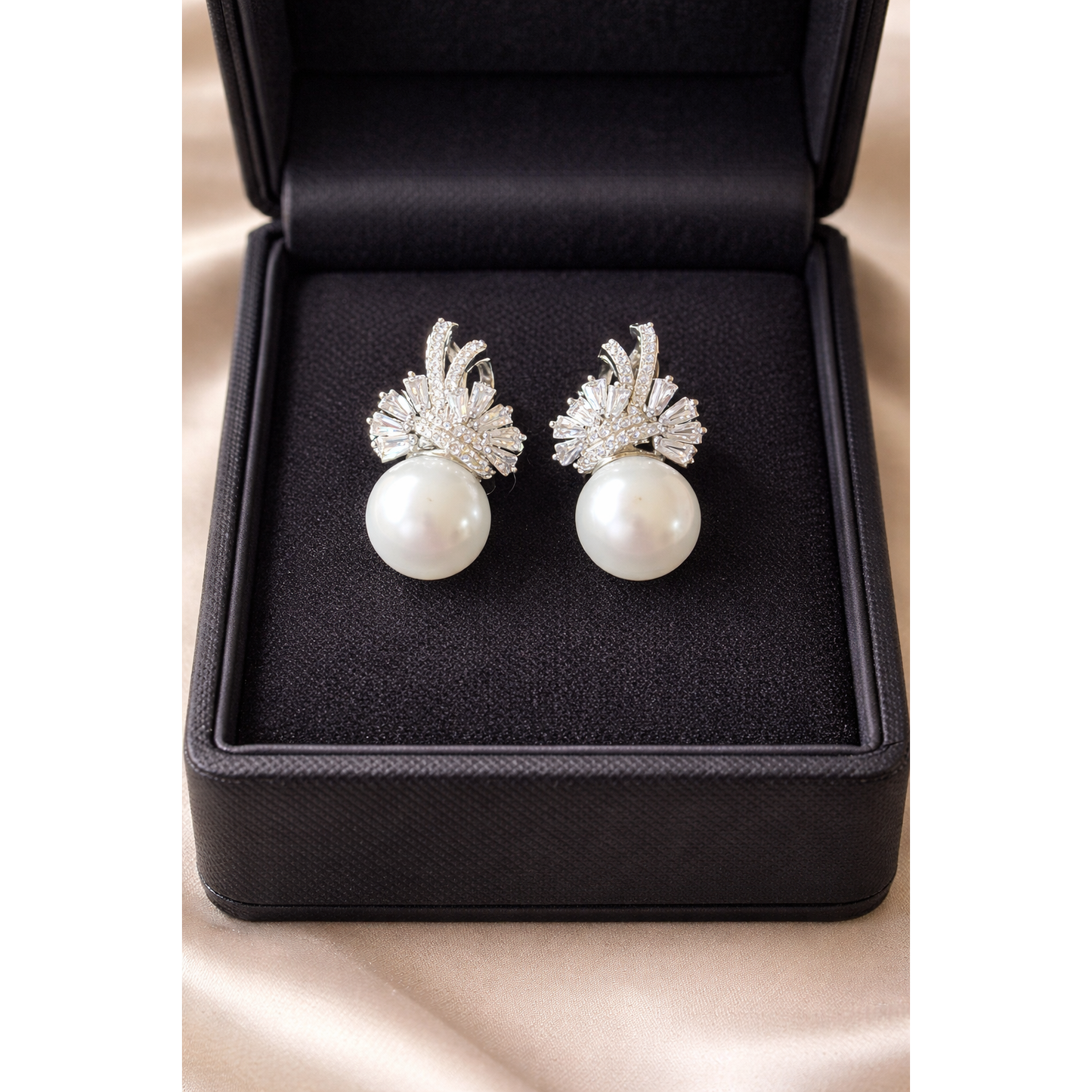 TIAS pearl drop earrings with crystal detailing in silver finish displayed inside a black jewellery box.”