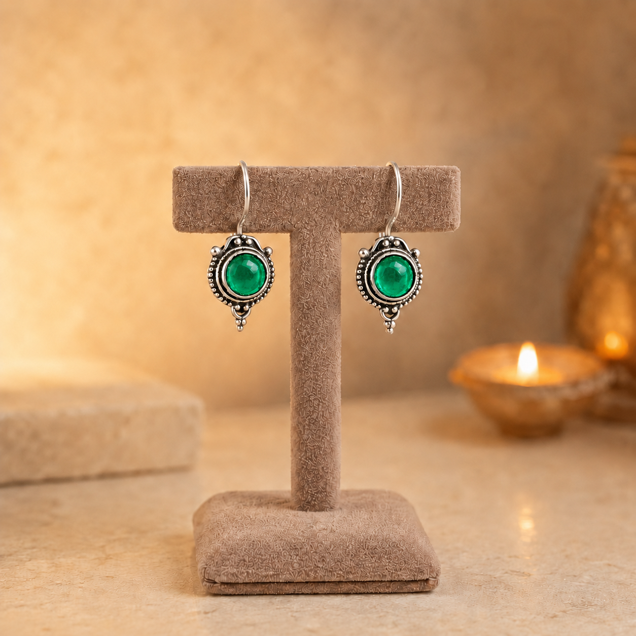 Antique silver vintage round  green gemstone drop earrings on beige velvet jewellery stand with polished cabochon