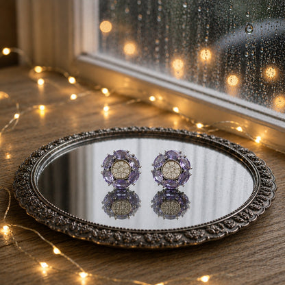 Floral crystal stud earrings with marquise-cut  lavender gemstone petals and a sparkling pavé center displayed on a decorative mirrored tray in a luxury jewelry photography setting.