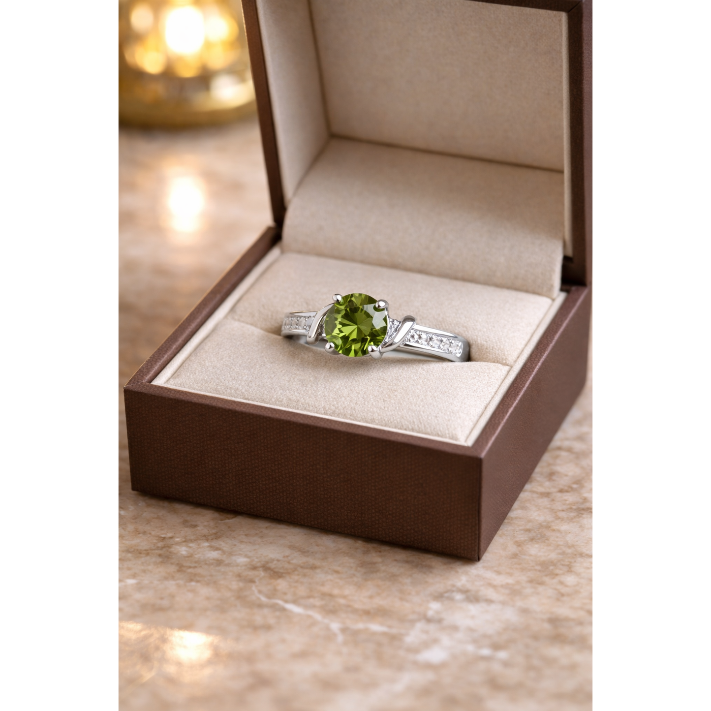 Round cut gemstone twist solitaire ring in silver olive  green gemstone finish displayed inside beige luxury jewelry box